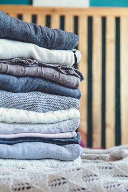 istock A stack of cozy warm winter clothes lies on the bed 1273292614