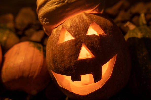istock Halloween decoration - Cutted pumpkin with a creepy smile and a candle inside 1273294464