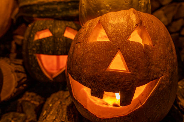 istock Halloween decoration - Cutted pumpkin with a creepy smile and a candle inside 1273294525