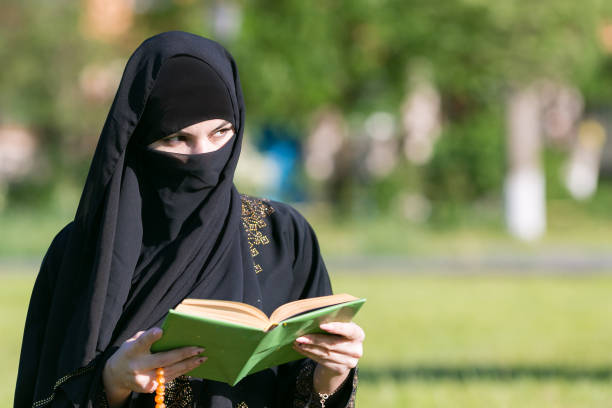 istock A woman from the East performs morning prayer while. 1273296269