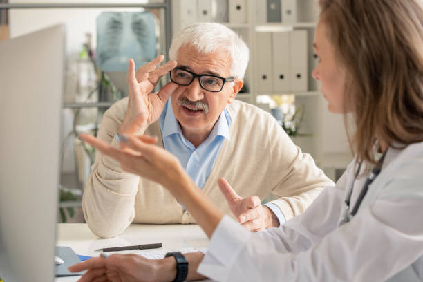 istock Senior patient in eyeglasses looking at results of analysis on computer screen 1273296454
