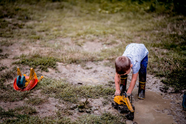 istock Little boy playing in the mud. 1273297206