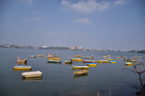 Small multicolor boats Small multicolor boats sailing in the lake, Bhopal bhopal lake stock pictures, royalty-free photos & images