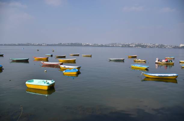 Small multicolor boats Small multicolor boats sailing in the lake, Bhopal bhopal lake stock pictures, royalty-free photos & images