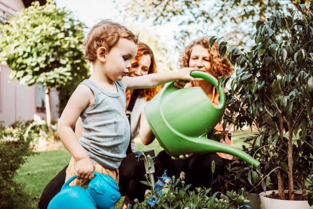 istock Family watering garden together 1273297775