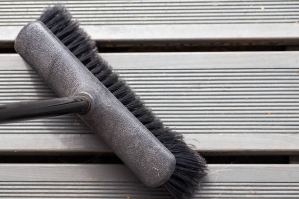 A broom and a dustpan are put.