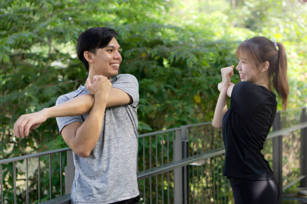 istock Happy couple doing body stretching in a park 1273300356