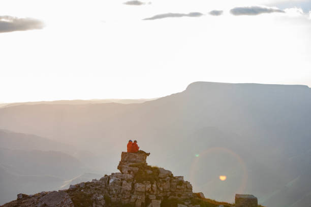 istock Young couple hiking at the mountains 1273303733