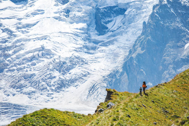 Father and son hiking together in mountains