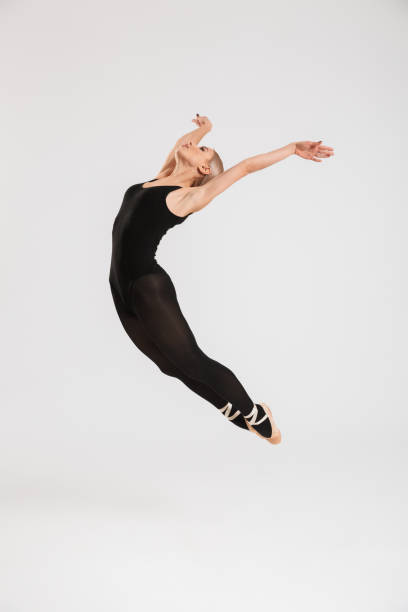 istock Young woman ballerina dancing 1273304020
