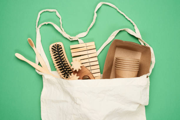 istock white textile bag and disposable tableware from brown craft paper, toothbrushes, comb 1273308953