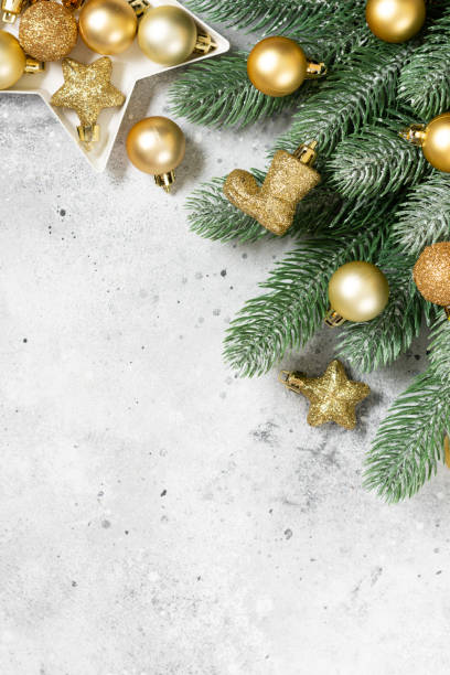 Christmas banner with a Christmas tree and gold decorations on a light background. Christmas or new year flatley. Copyspace