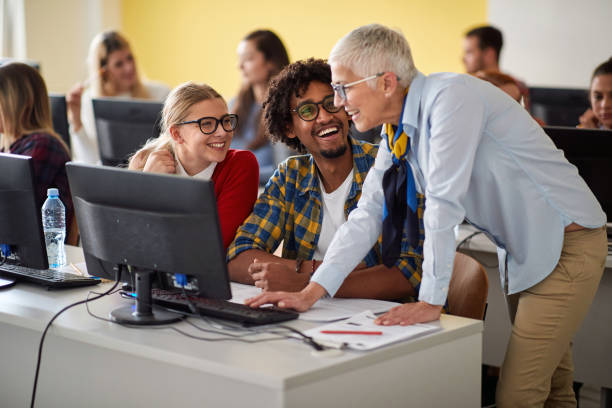 istock Female professor with pupils looking in computer 1273309424