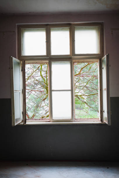 istock Barred window in a destroyed room, a prison of the mind 1273309450