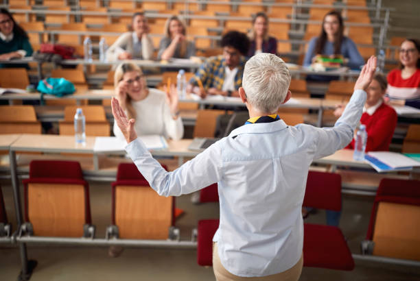 istock Back view of professor with students in amphitheater 1273309547
