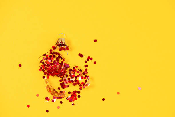 istock broken Christmas tree ornament ball on yellow background. broken old xmas decorations 1273310130
