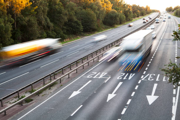 istock Lorries with motion blur viewed from bridge over dual carriageway late afternoon 1273313701