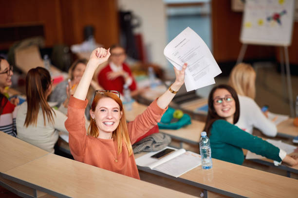 istock Happy student showing her very well done test 1273314647