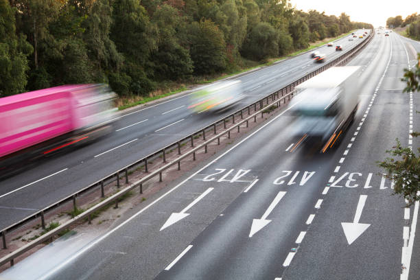 istock Lorries with motion blur viewed from bridge over dual carriageway early evening 1273315533