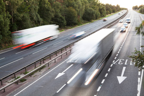 istock Lorries with motion blur viewed from bridge over dual carriageway early evening 1273315828