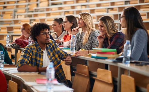 istock Group of students sitting in amphitheater 1273317600