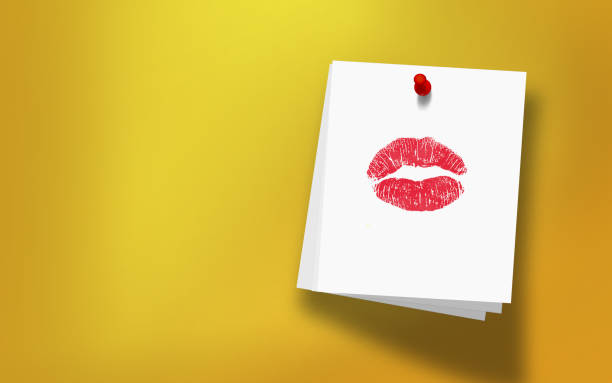 Kiss shape lipstick mark on white sticky note paper attached with red push pin on yellow background. Realistic design with copy space. High resolution image to crop your design needs.