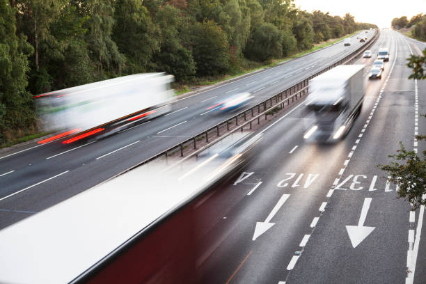 istock Lorries with motion blur viewed from bridge over dual carriageway early evening 1273319211