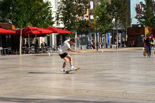 Clermont Ferrand - 08/24/2020 : a young man skater in Place de Jaune, doing tricks