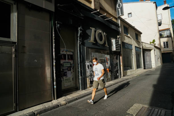 Clermont Ferrand - 08/24/2020 : young man with mask passing by club discoteque 101, 3 Rue du Coche, 63000 France