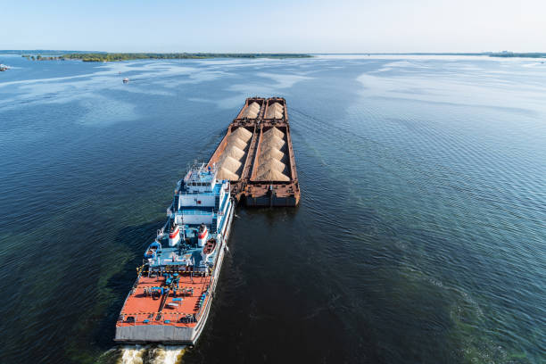 istock A large barge with sand sails along the coast along the wide Volga river 1273321736