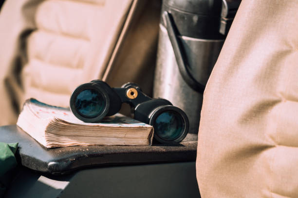 istock Binocular and book lying in the car 1273321765