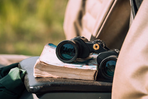 Binocular and book lying in the car