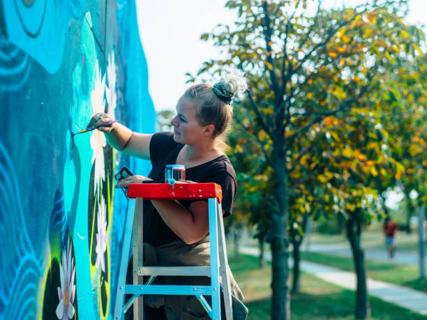 istock Female mural artist at work 1273321801