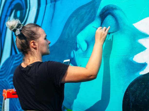 istock Female mural artist at work 1273321867