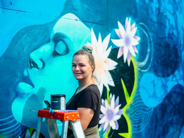 istock Female mural artist at work 1273321944