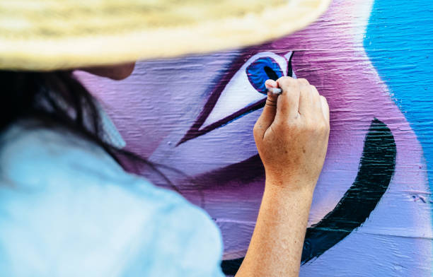 istock Hand of Female mural artist at work 1273322014