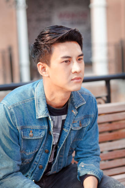 istock Thoughtful in distance looking young thai man 1273322888