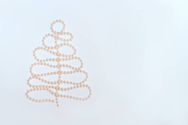 pearl beads in christmas tree shape on white background. - christmas tree bead humor imagens e fotografias de stock