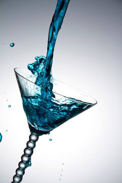 istock blue water is splashing at coctail glass 1273326318