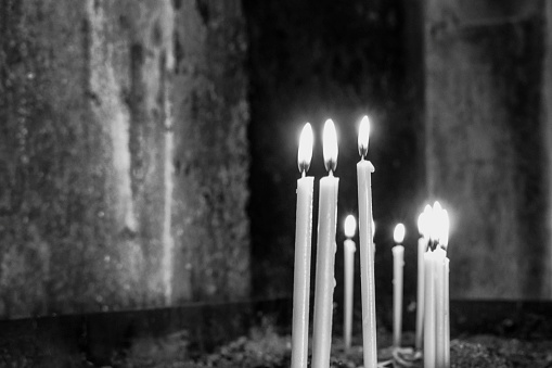 Monochrome image. Burning candles. Armenia. Church of Amberd.