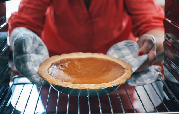 istock Baking Pumpkin Pie for the Holidays in the Oven 1273328036