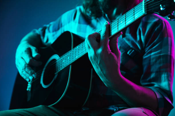 istock Close up of guitarist hand playing guitar, copyspace, macro shot 1273328984