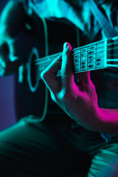 istock Close up of guitarist hand playing guitar, copyspace, macro shot 1273329004