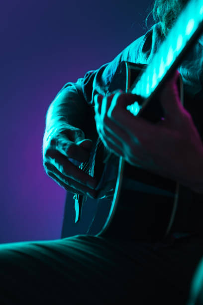 istock Close up of guitarist hand playing guitar, copyspace, macro shot 1273329007