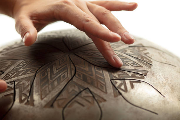 istock A close up of hands playing the hank drum on white studio background 1273333486