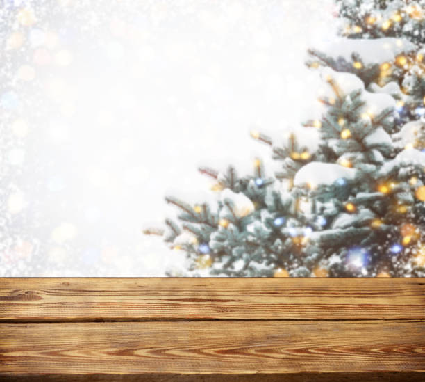 istock Christmas tree branches with wooden background 1273334358