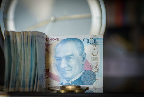 Conceptos de dinero y tiempo. Lira turca y reloj analógico. photo