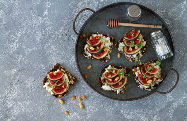 istock Fig sandwiches with mascarpone, honey and nuts on tray from above view 1273334616