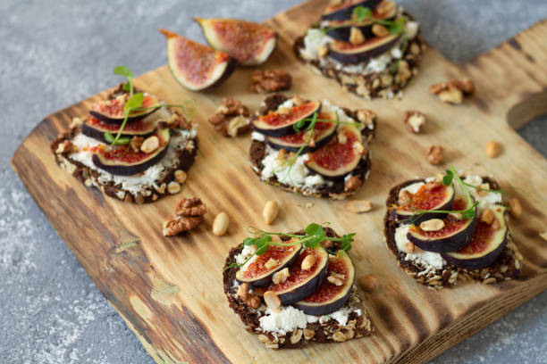 istock Toast with figs, honey, cheese and nuts on rustic wooden board 1273334622