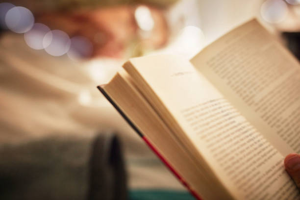 Closeup shot of an unrecognizable person reading a book